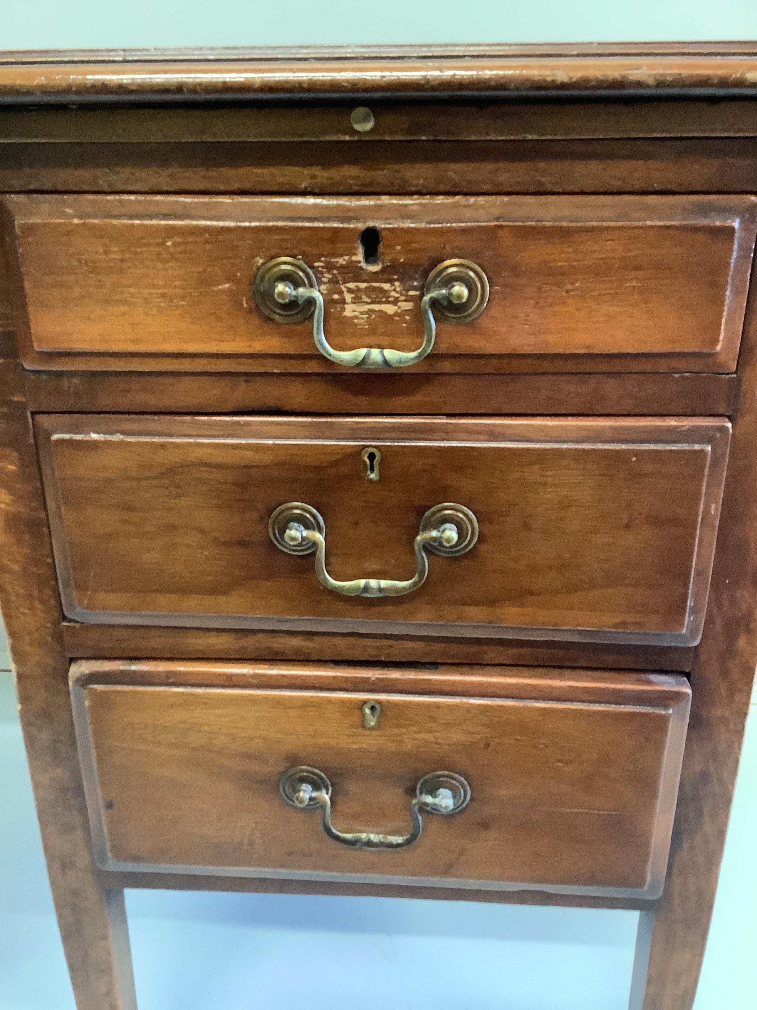 An early 20th century mahogany and beech four drawer kneehole writing desk, width 107cm, depth 60cm, height 75cm, together with a Victorian mahogany hall chair